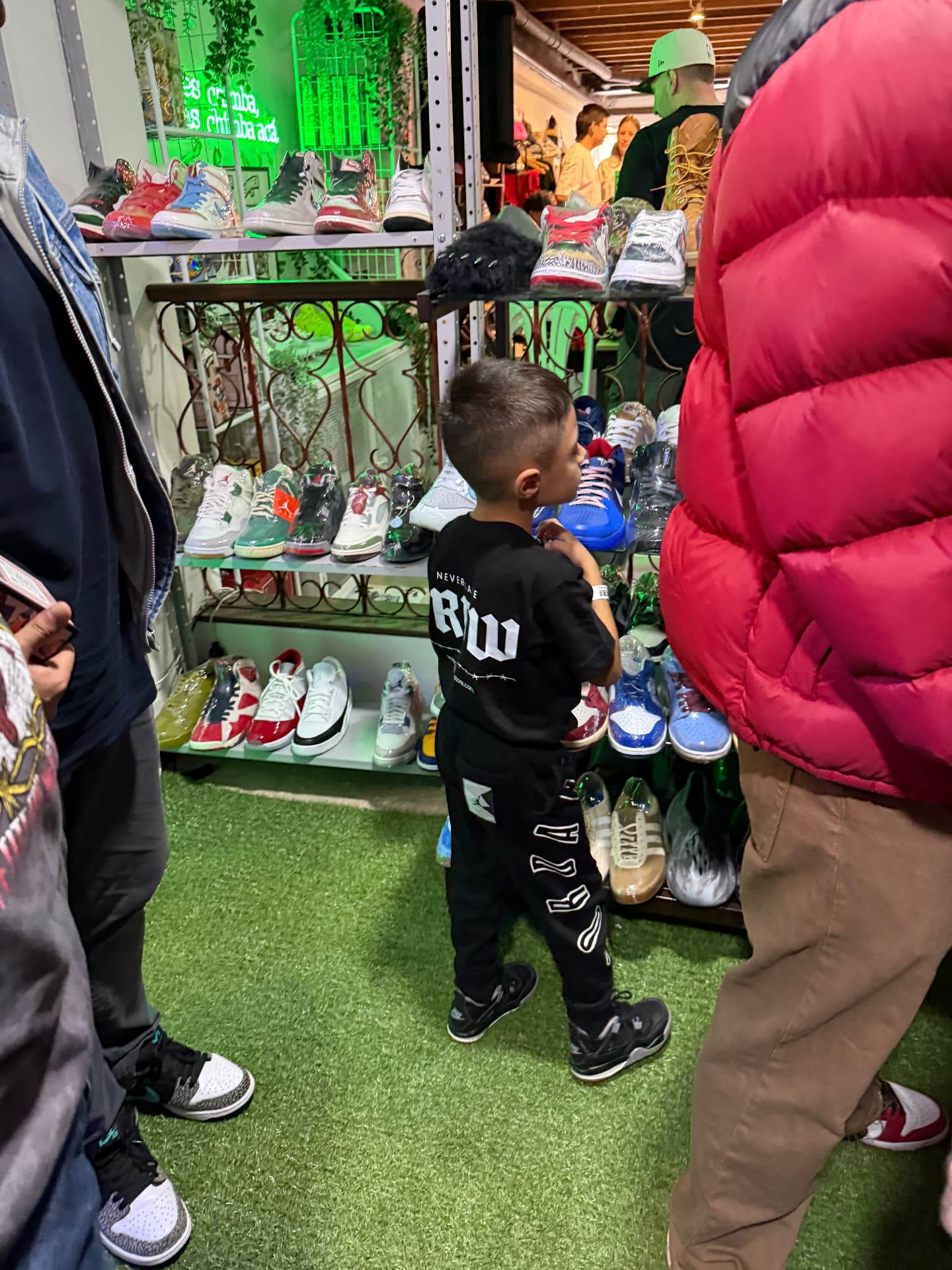 A young sneakerhead looking at the sneaker wall