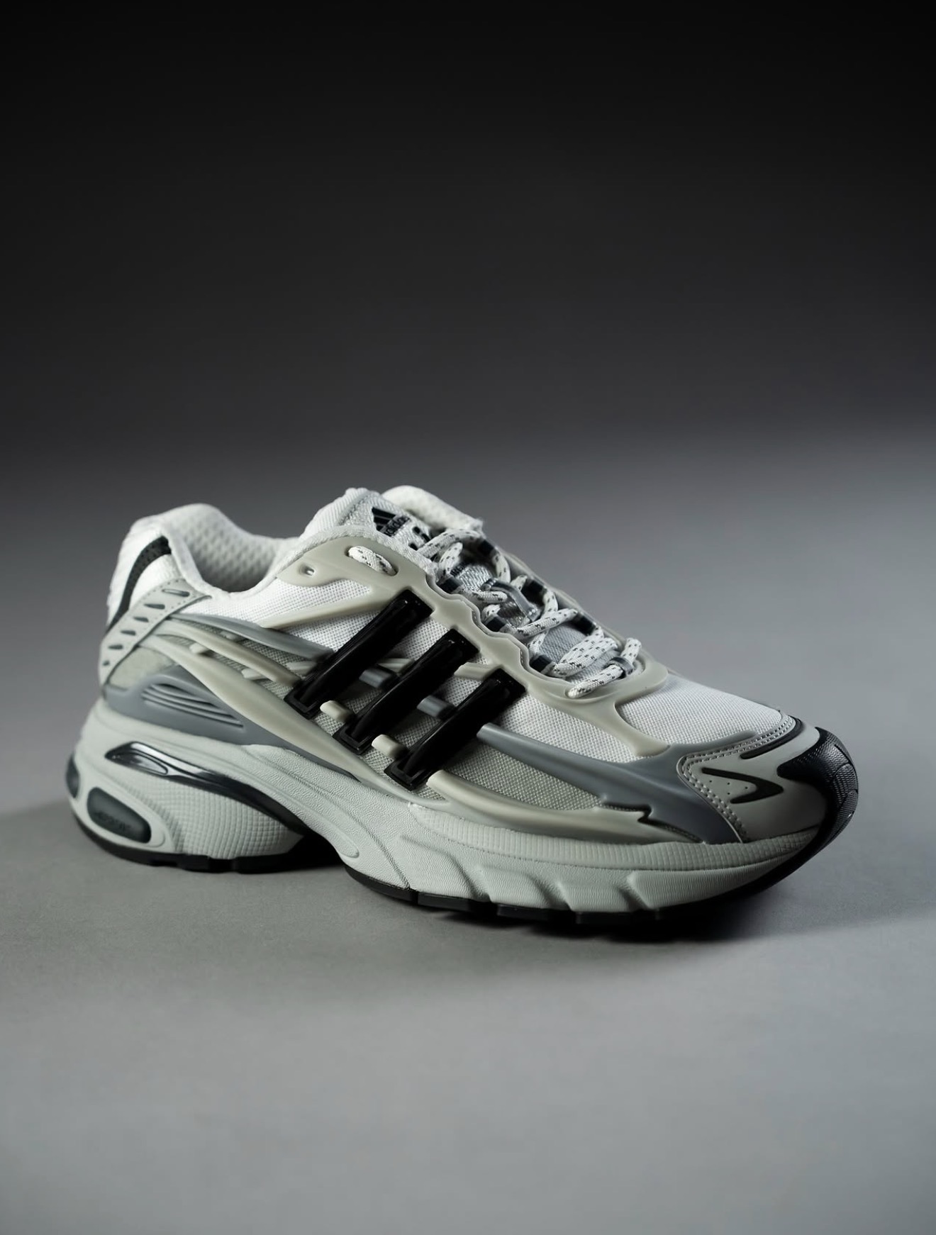 White and grey adidas runner in studio light — Holy Grail